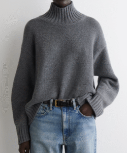 a model posing in a grey turtleneck sweater