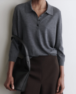 model posing in a basic grey polo sweater